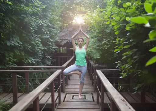 Woman practicing yoga in a tropical Bali retreat during a 7-day wellness itinerary