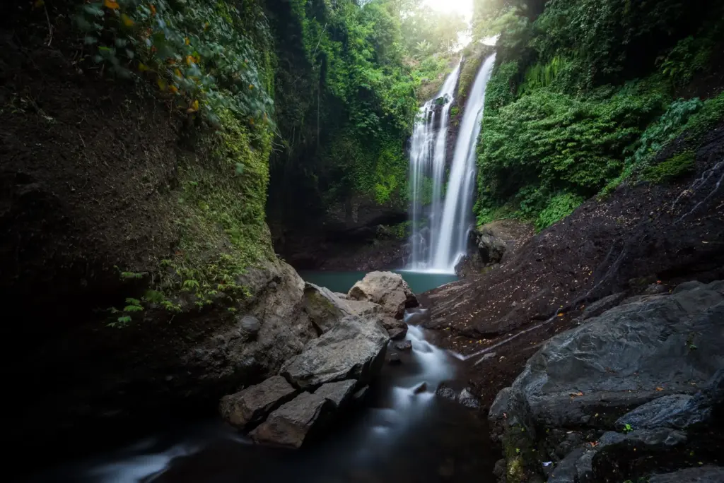 Aling Aling Waterfall in Sambangan Bali surrounded by lush jungle and natural pool