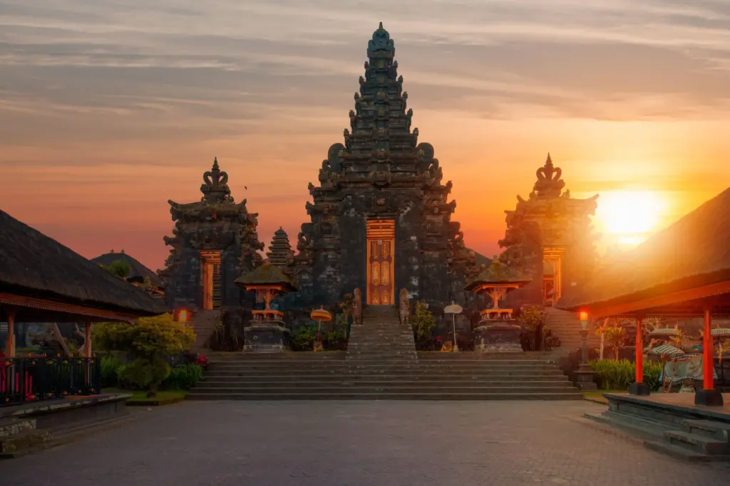 Besakih Temple Bali at sunset with golden sky over Mount Agung