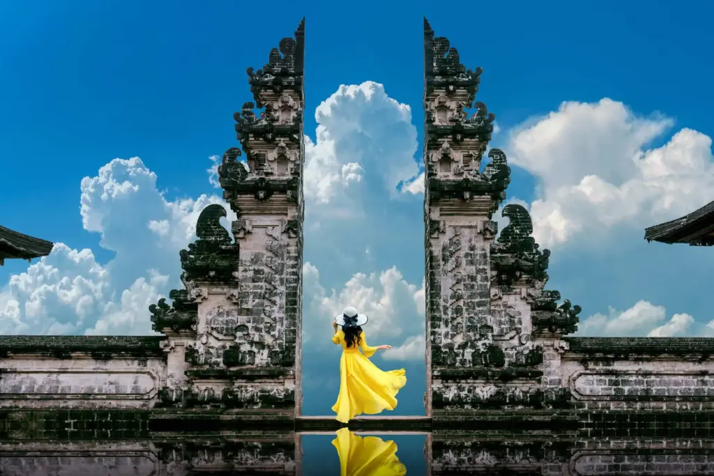Traveler posing at Bali’s Lempuyang Temple, highlighting the impact of overtourism in sacred spaces