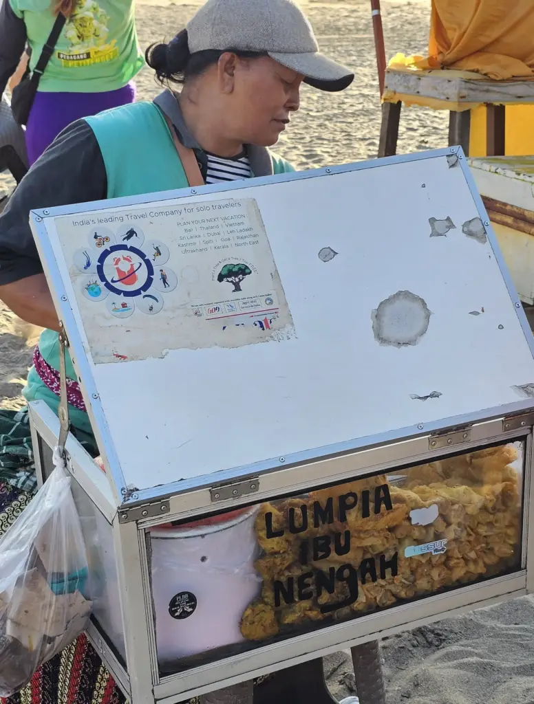 Nengah preparing gorengan at her food cart on Petitenget Beach, Bali