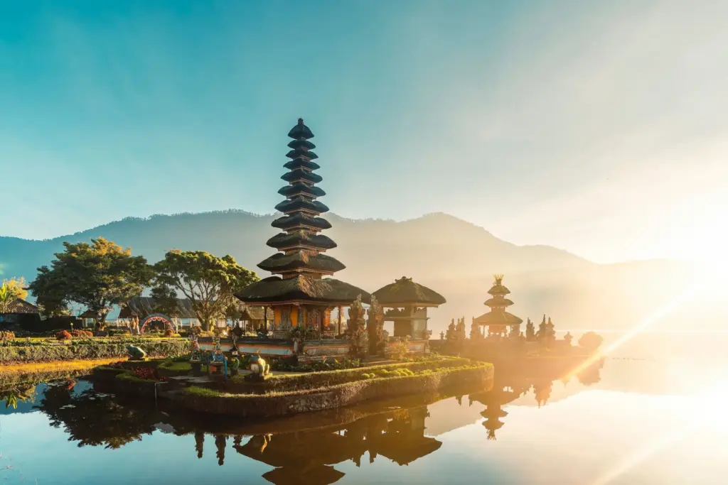 Ulun Danu Beratan Temple at sunrise on Lake Beratan in Bali, one of the most iconic Bali temples surrounded by mountains and water.